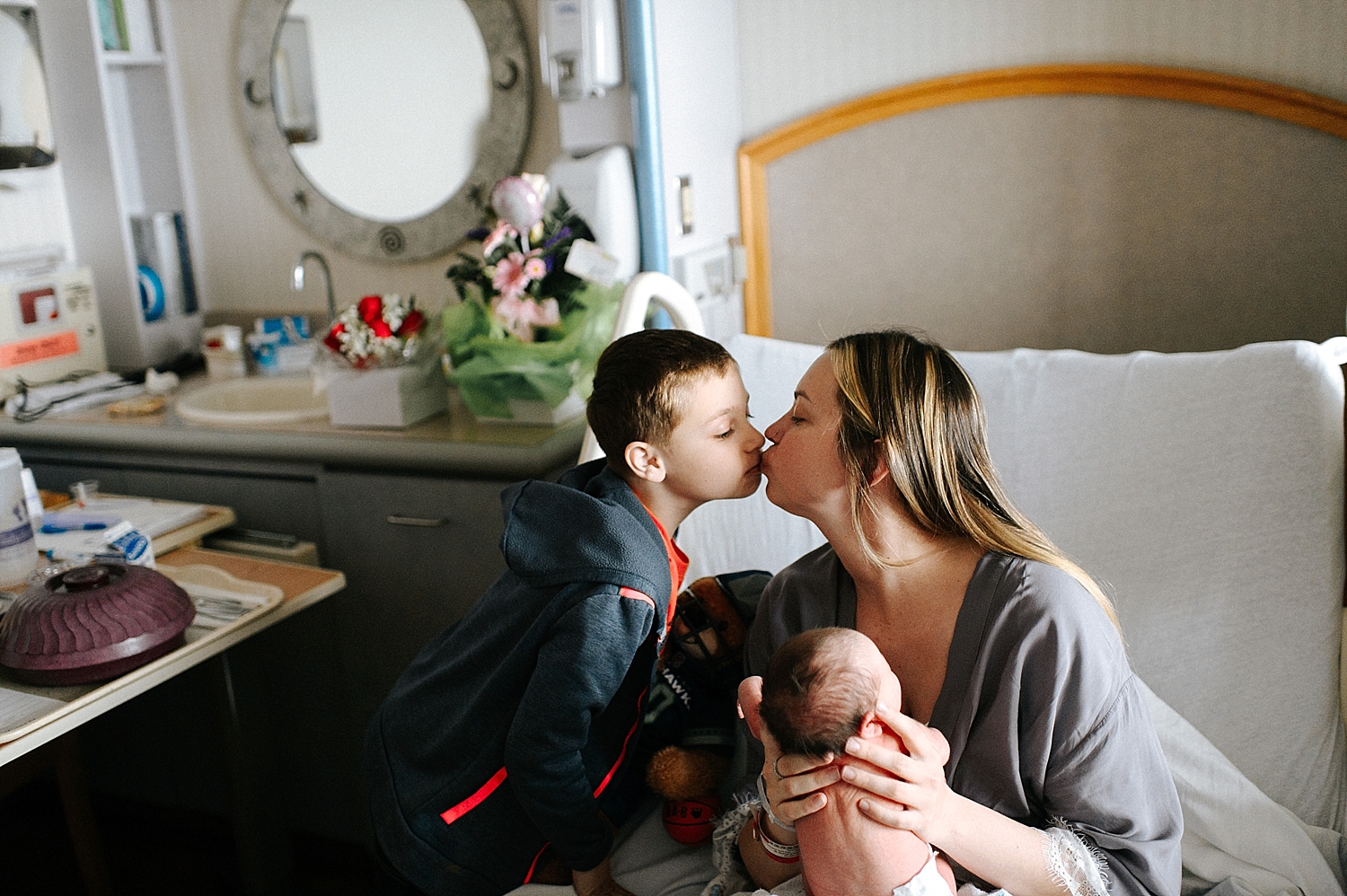 Mama with her two little ones during baby sisters Fresh48 Hospital session with Meg Newton Photography