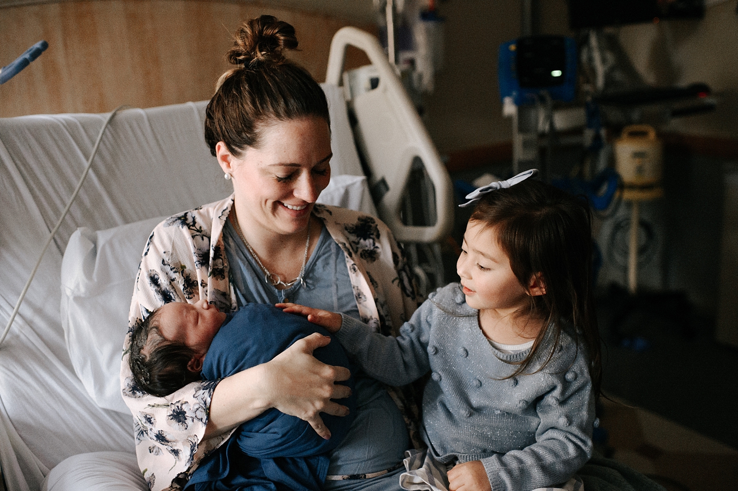 Mama with big sister and newborn baby during Hospital Fresh48 Session with Meg Newton Photography