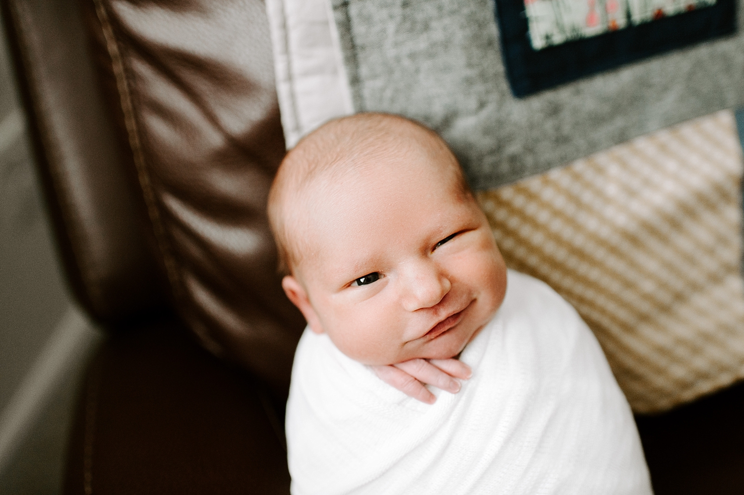 Baby boy swaddled for picture during lifestyle newborn session | Meg Newton Photography