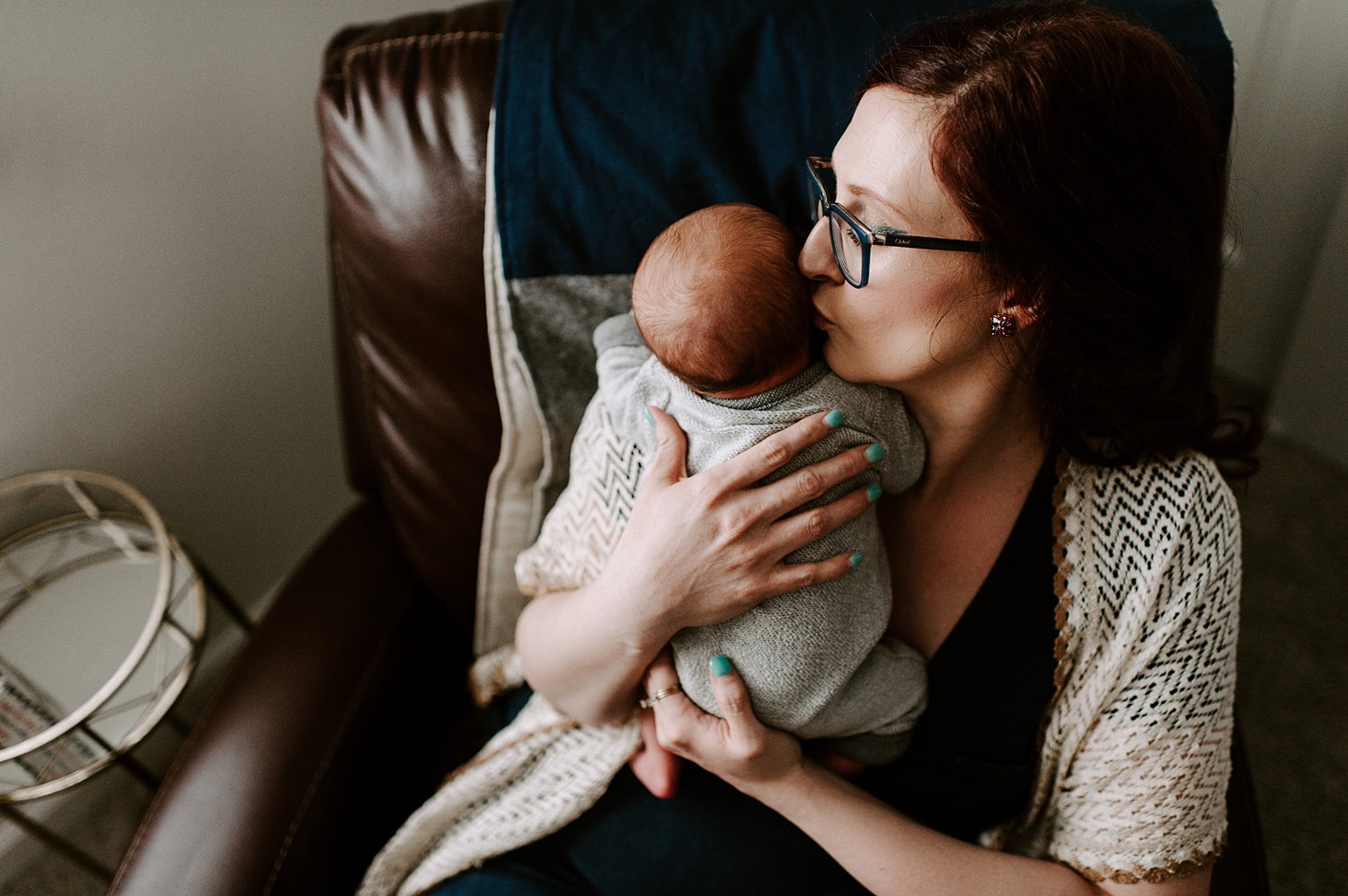 Mama calms and rocks baby during newborn photoshoot | Meg Newton Photography 