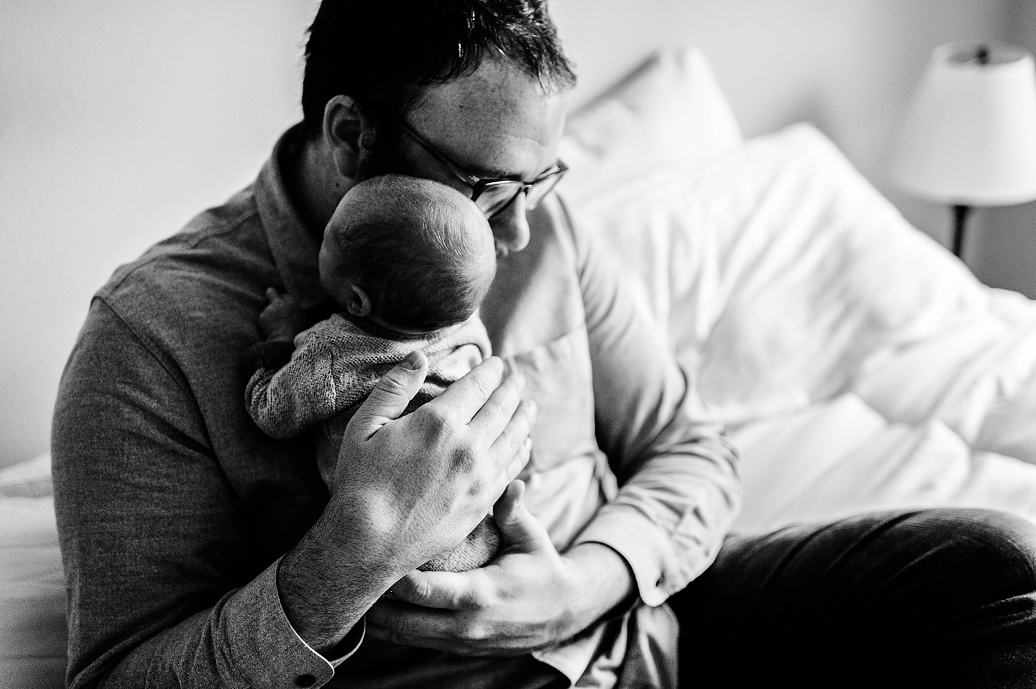 Dad snuggles baby during newborn session with Olympia Lifestyle Newborn Photographer, Meg Newton Photography 