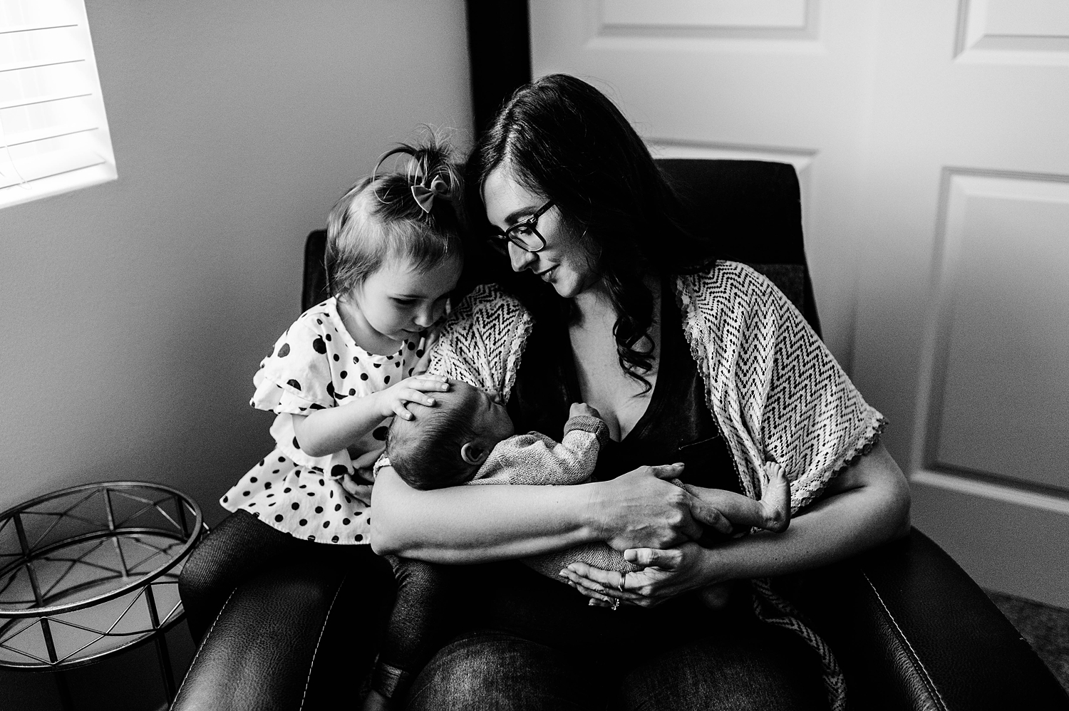 Big sister adoring her baby brother during his lifestyle newborn photoshoot in Olympia, WA | Meg Newton Photography 