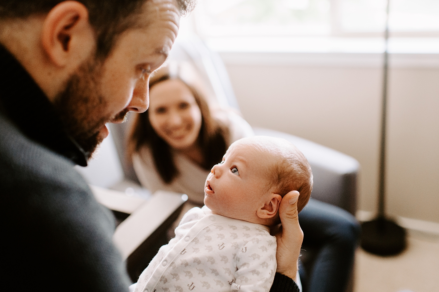 Baby boy looking at dad during his lifestyle newborn session with Seattle Lifestyle Newborn Photographer, Meg Newton Photography 