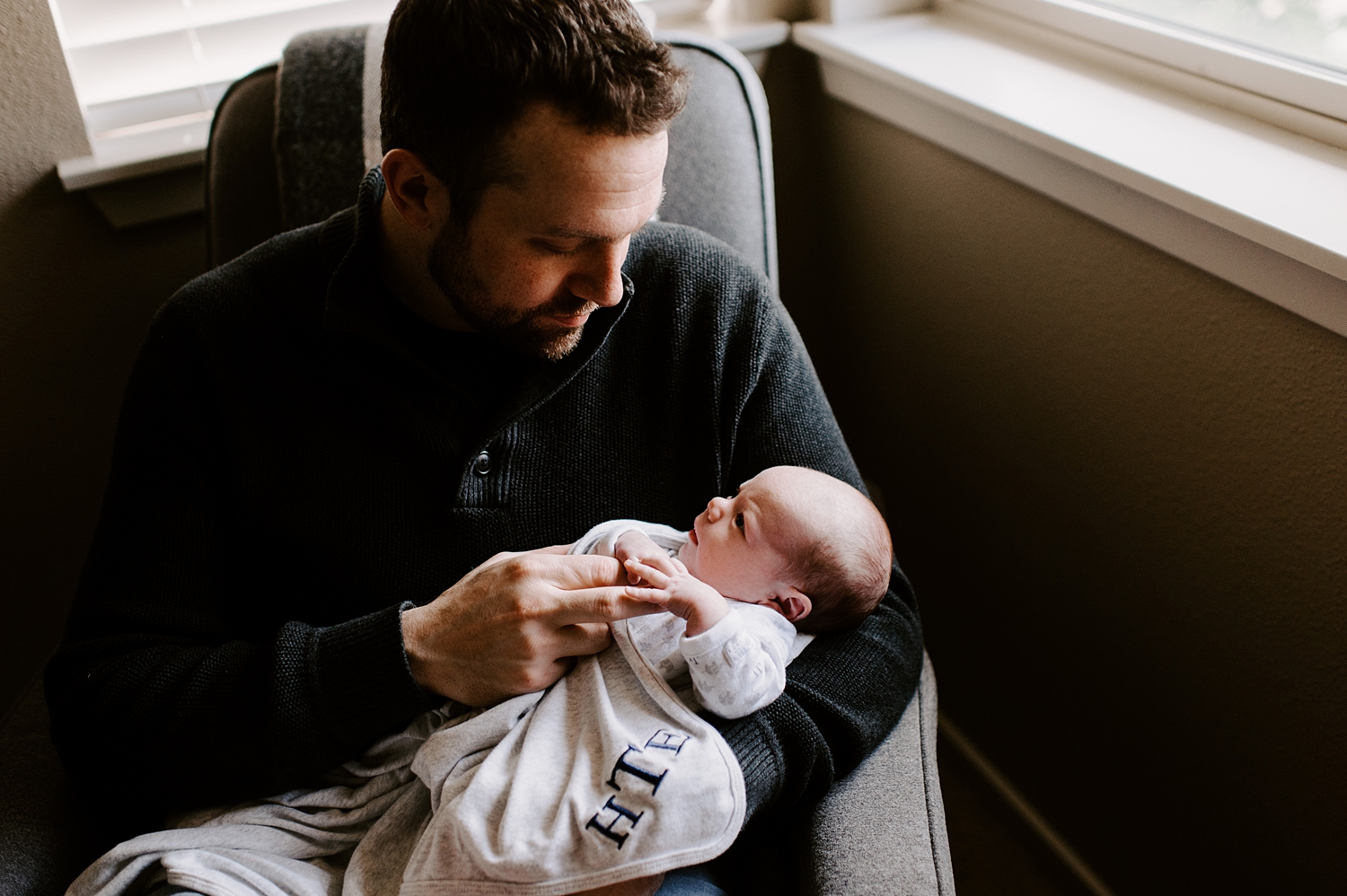 Dad with baby in nursery for lifestyle newborn session with Tacoma-Seattle Newborn Photographer, Meg Newton Photography 