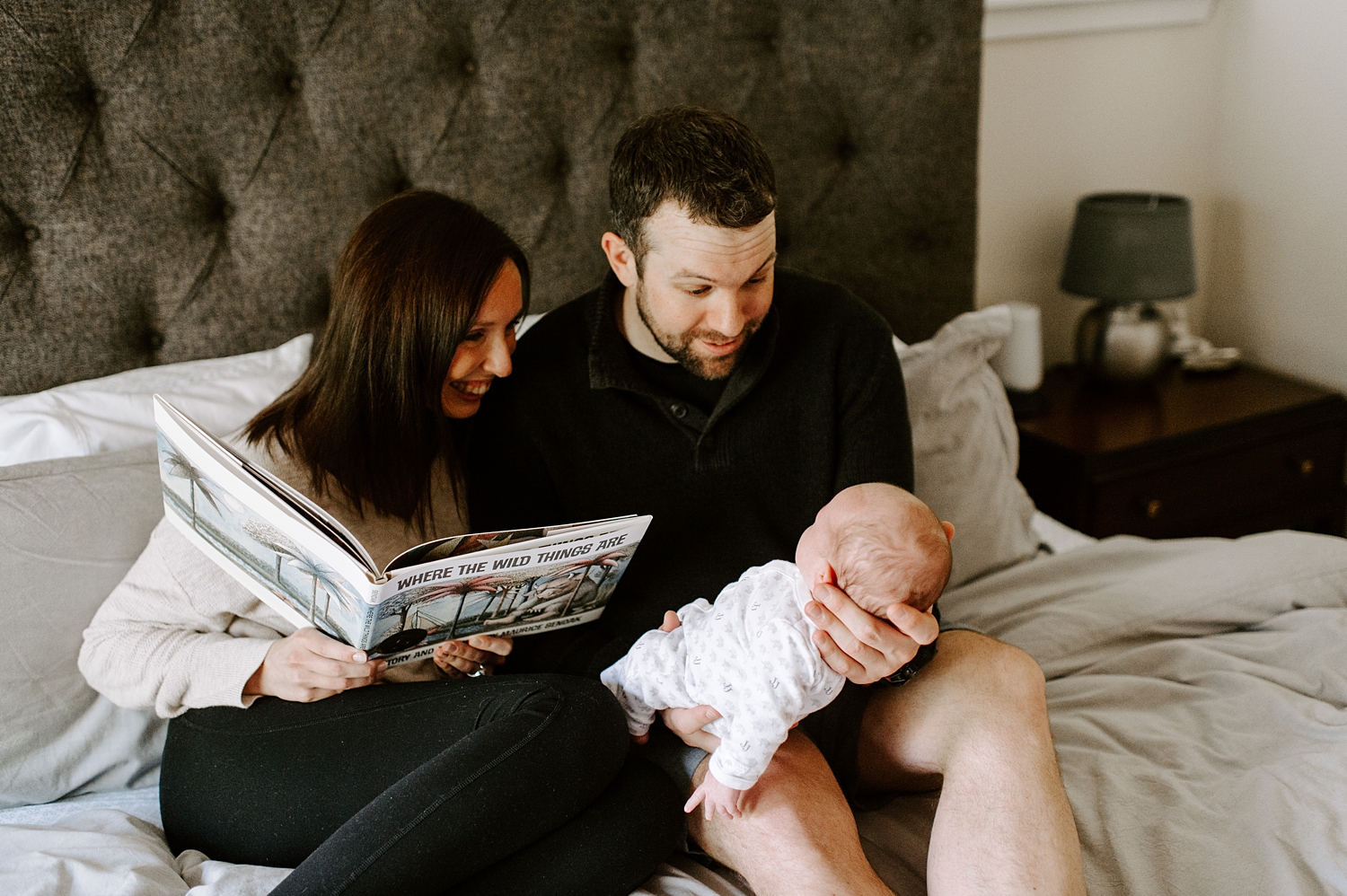 Parents reading "Where the Wild Things Are" to newborn baby during newborn session with Seattle Lifestyle Newborn Photographer, Meg Newton Photography 