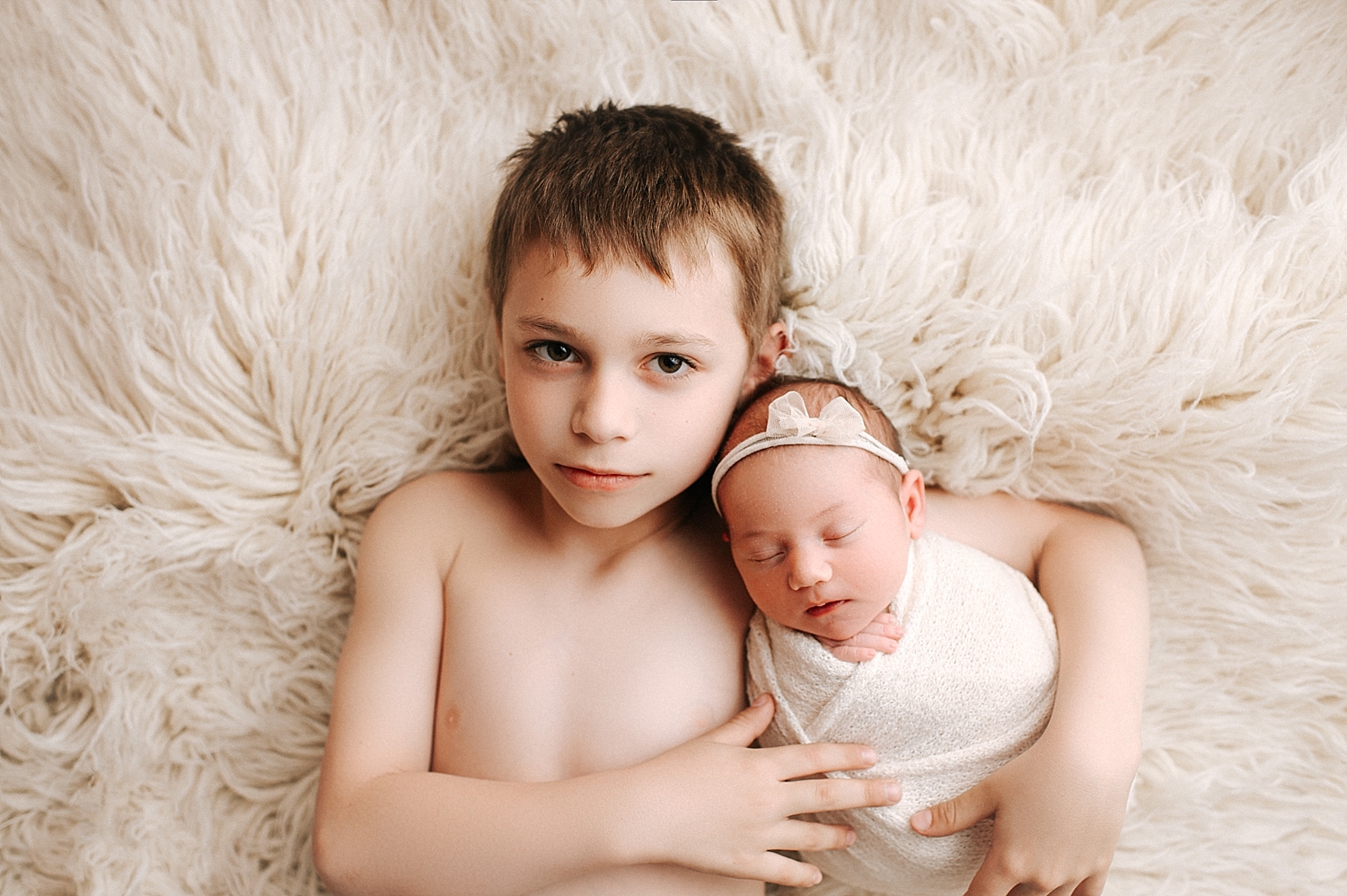 Big brother with newborn baby sister during Tacoma Newborn Session with Meg Newton Photography