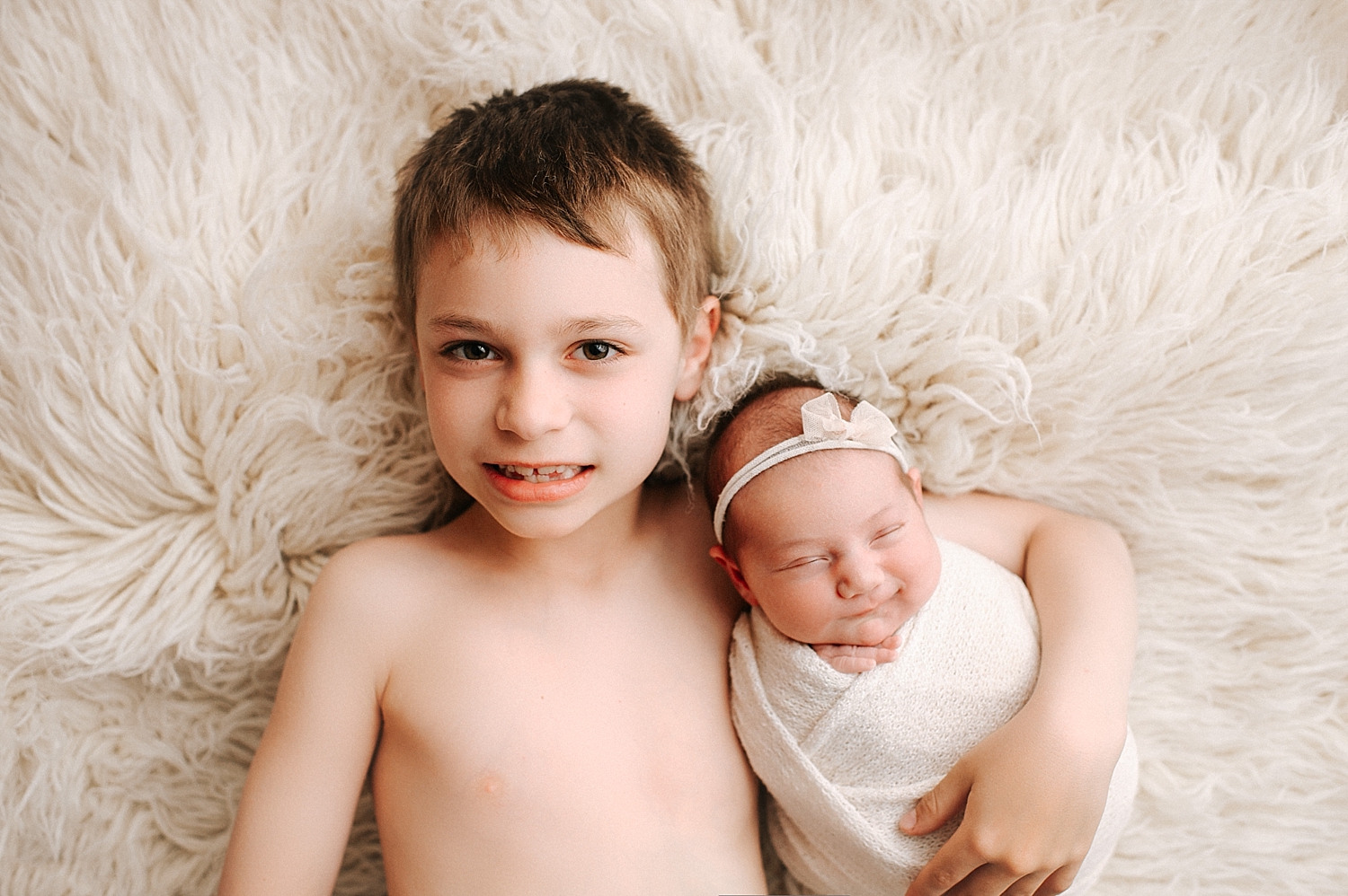 Big brother with newborn baby sister during Tacoma Newborn Session with Meg Newton Photography