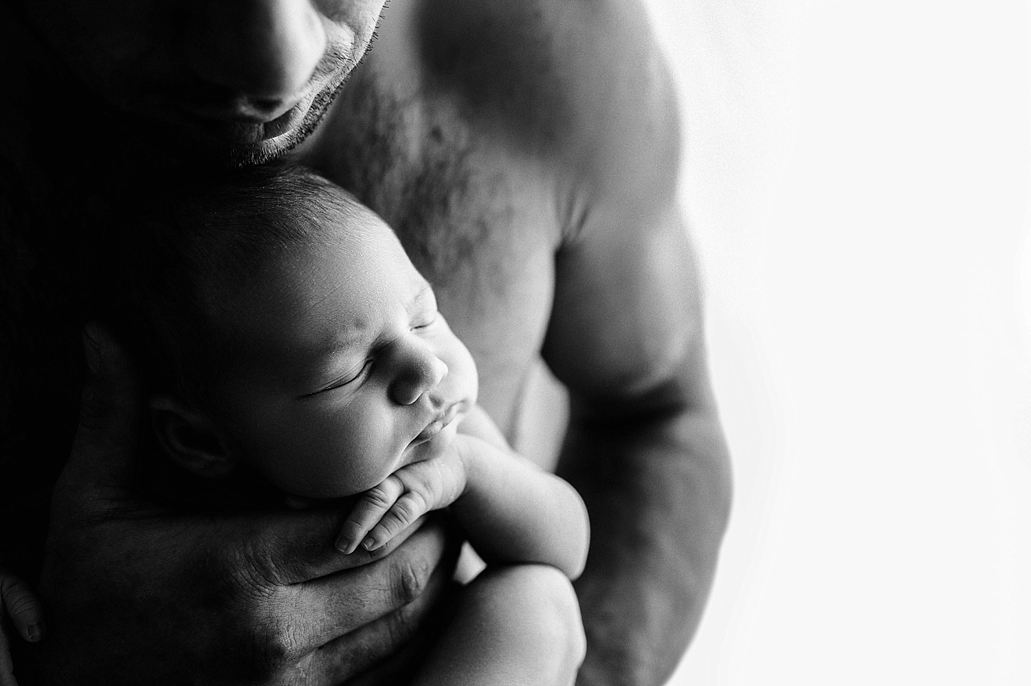 Dad with baby girl during newborn session with Meg Newton Photography