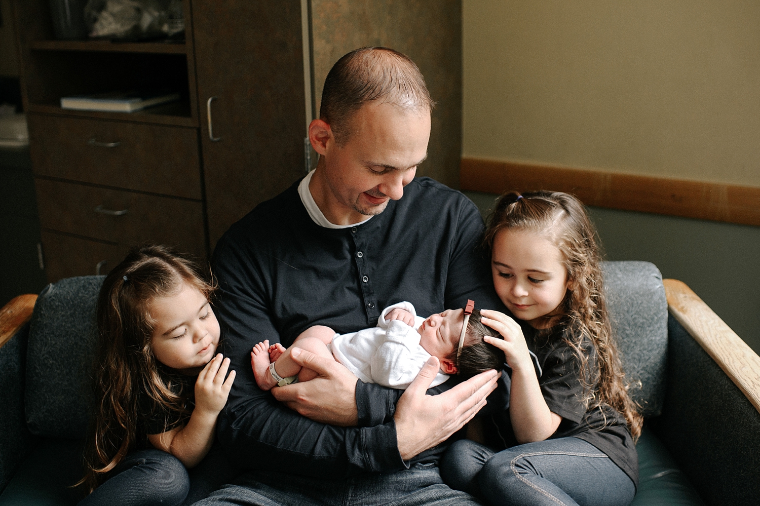 Dad with three girls during baby's fresh48 hospital newborn session at Providence St. Peters Hospital in Olympia, WA | Meg Newton Photography