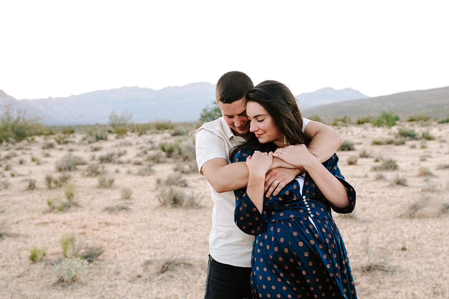 Couple maternity photoshoot in the Las Vegas Red Rocks. Photographed by Meg Newton Photography