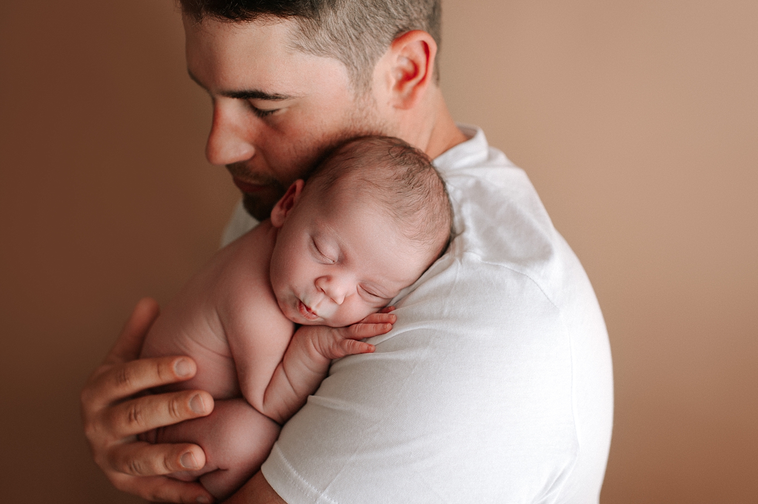 Dad with newborn baby girl during posed newborn session with Tacoma Newborn Photographer, Meg Newton Photography