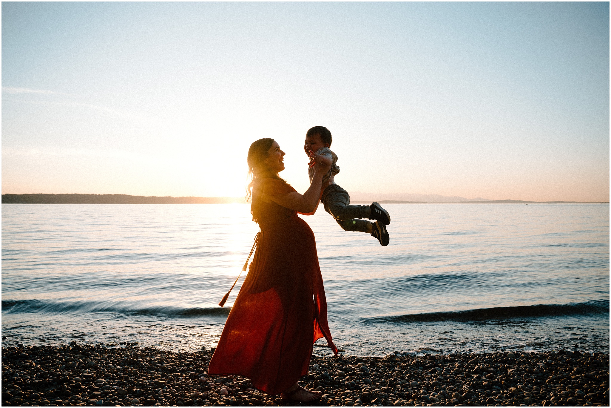 Mama spins her baby boy while being backlit by the sun. Photo by Meg Newton Photography.