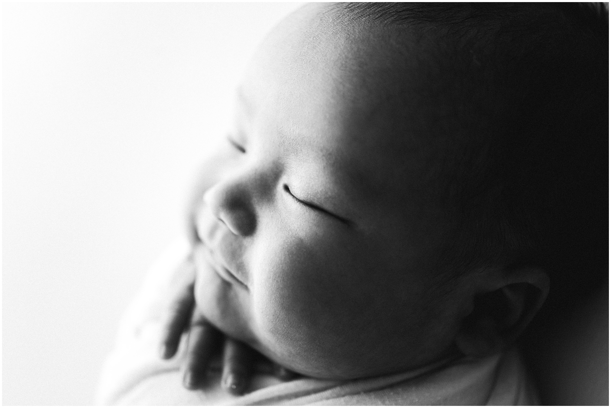 Black and white profile image of baby boy. Photo by Meg Newton Photography.