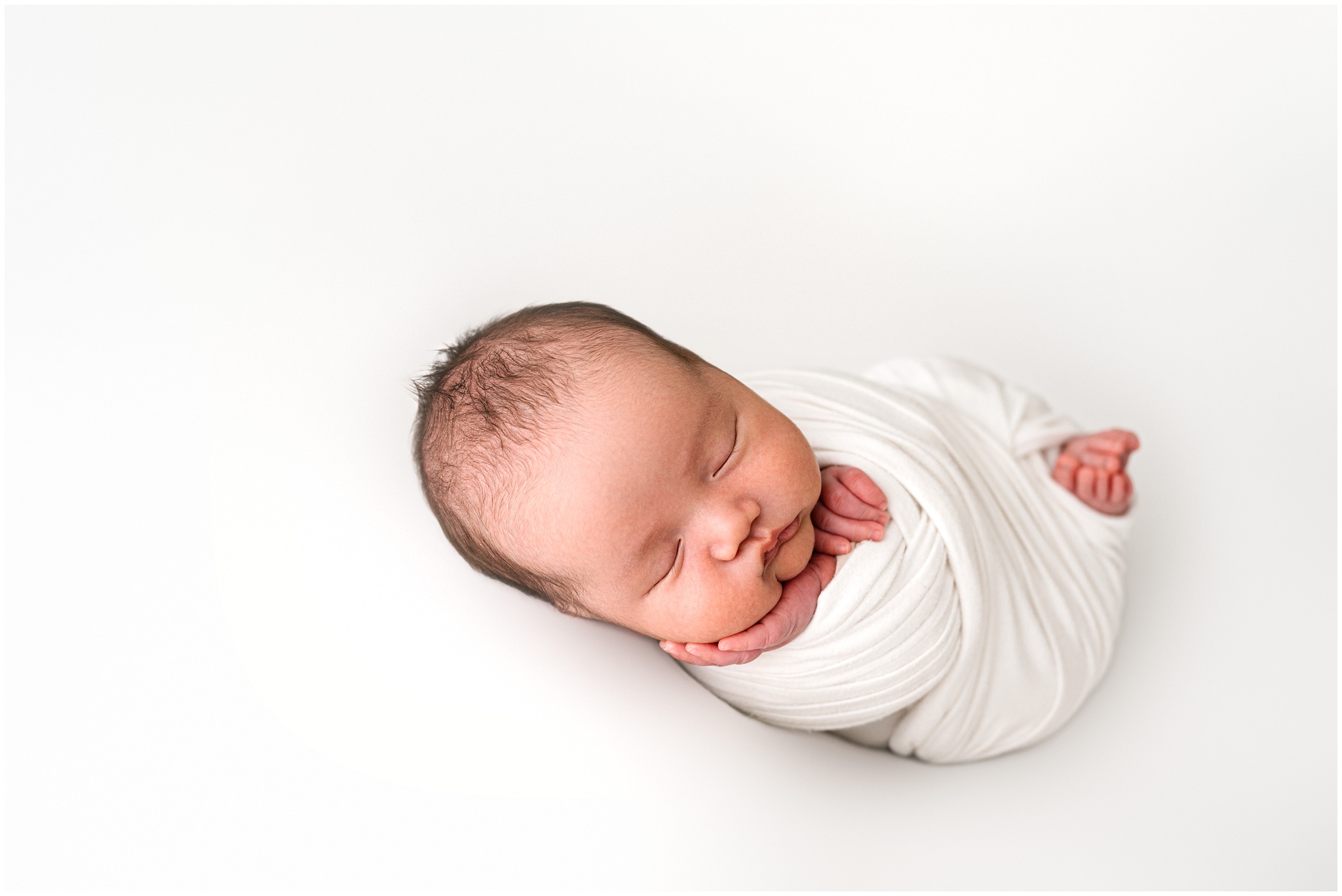Simple studio newborn pose. Photo by Meg Newton Photography.