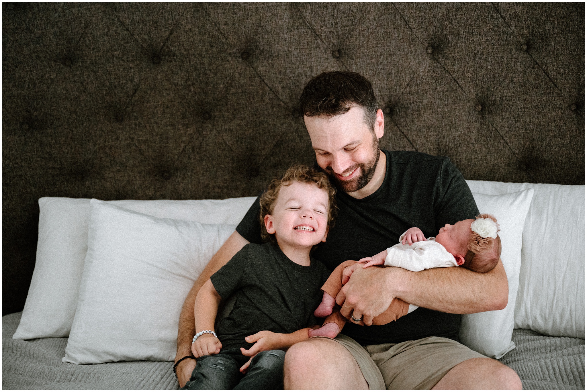 All smiles for dad and son holding new baby sister. Photo by Meg Newton Photography.