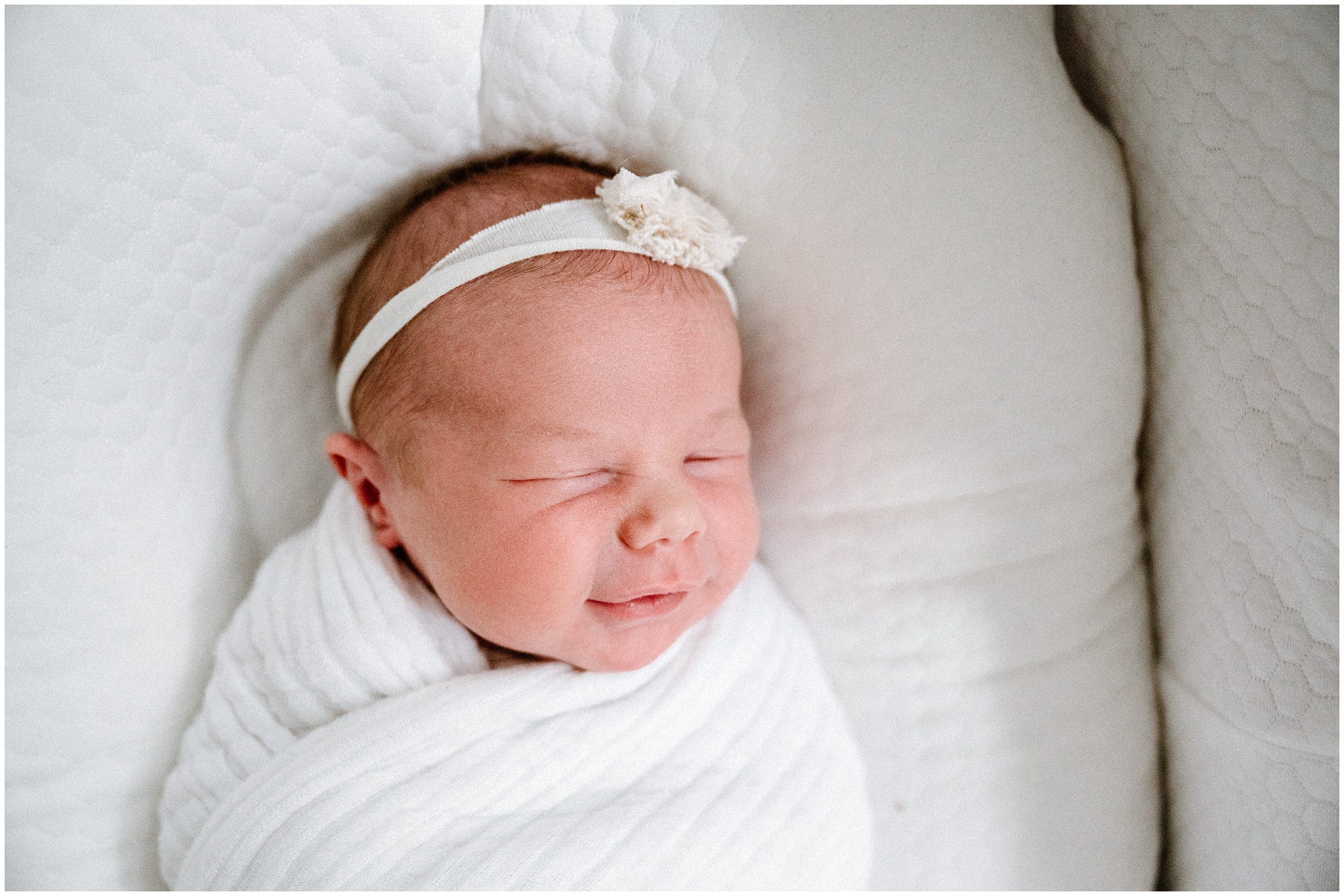 Baby girl giving a wink. Photo by Meg Newton Photography.