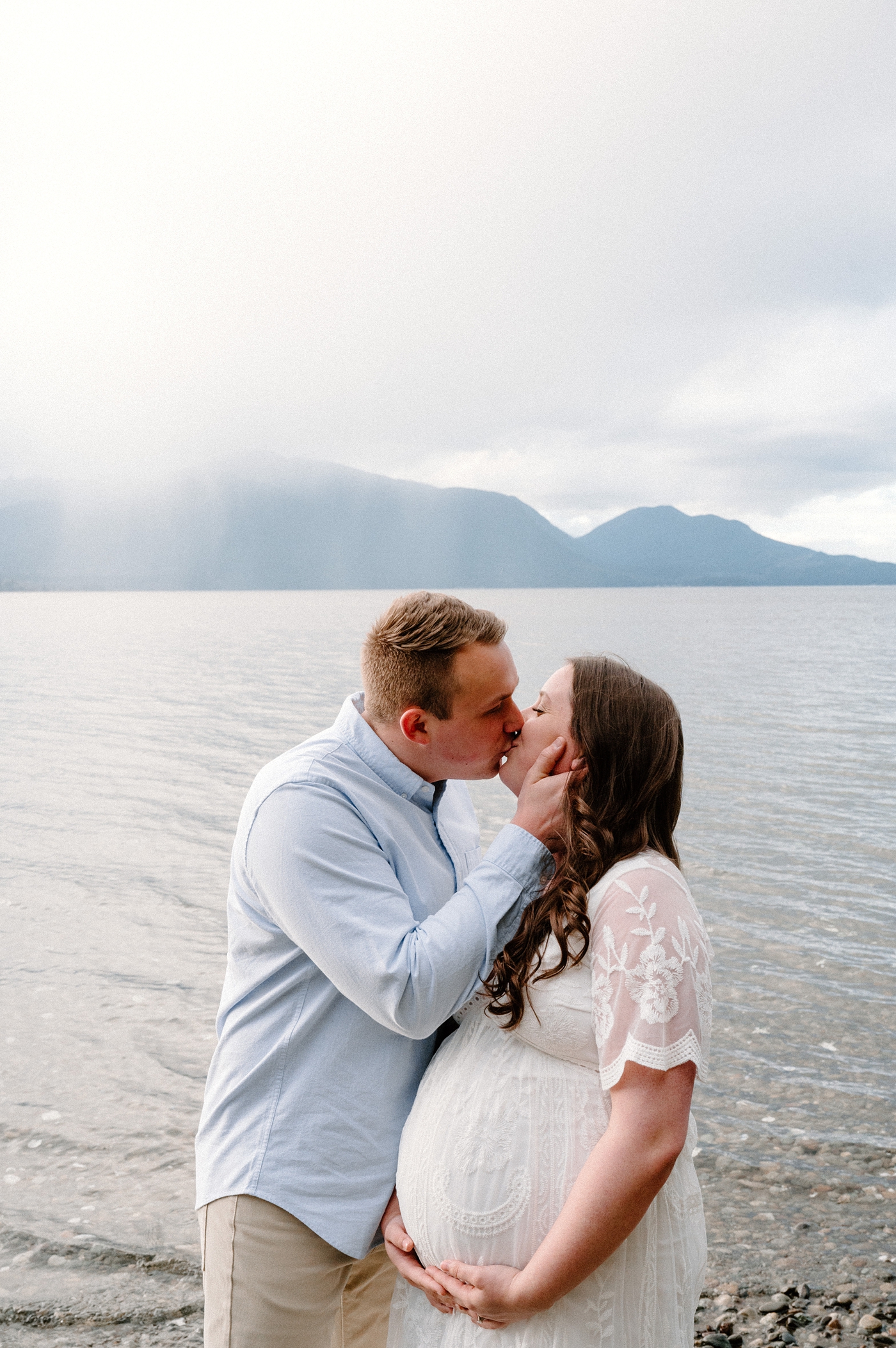 Dad goes in for a kiss during Gig Harbor maternity session. Photo by Meg Newton Photography.