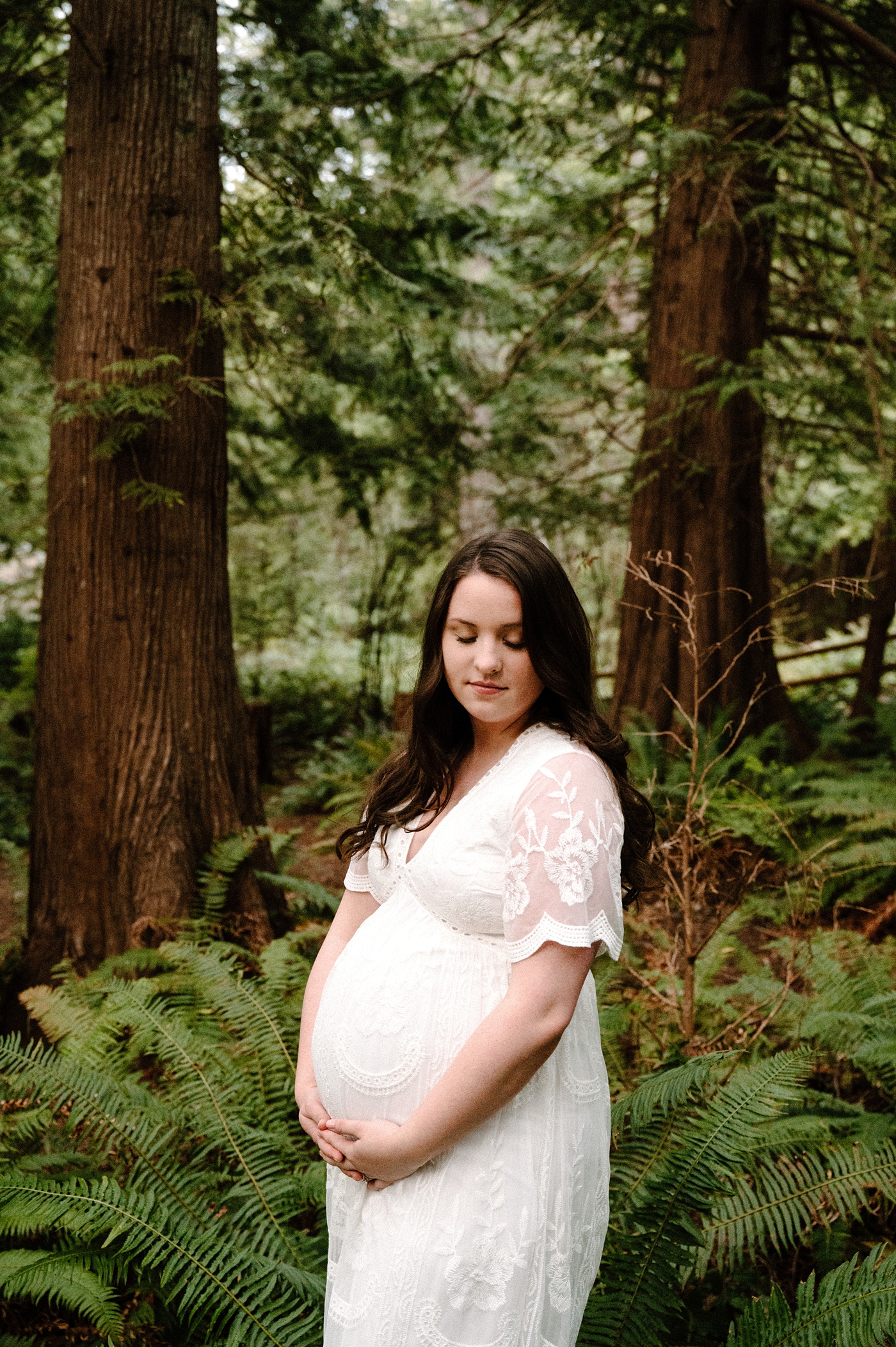 Mama to be holds pregnant belly during Gig Harbor maternity session. Photo by Meg Newton Photography.