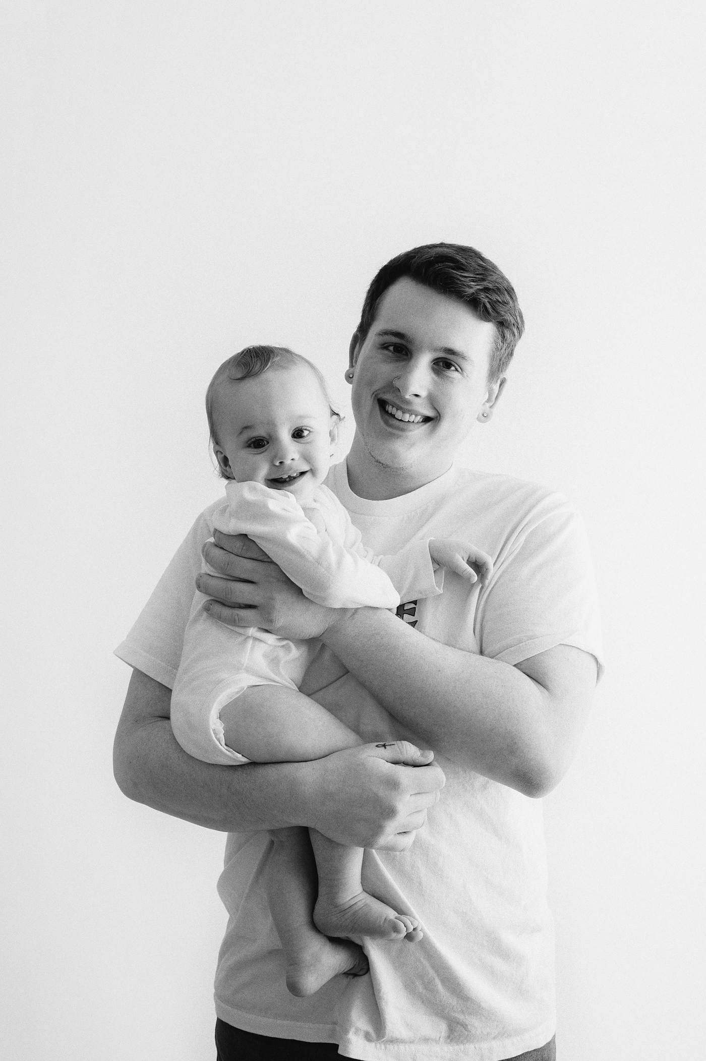 Dad holds his son during Seattle studio session. Photo by Meg Newton Photography.