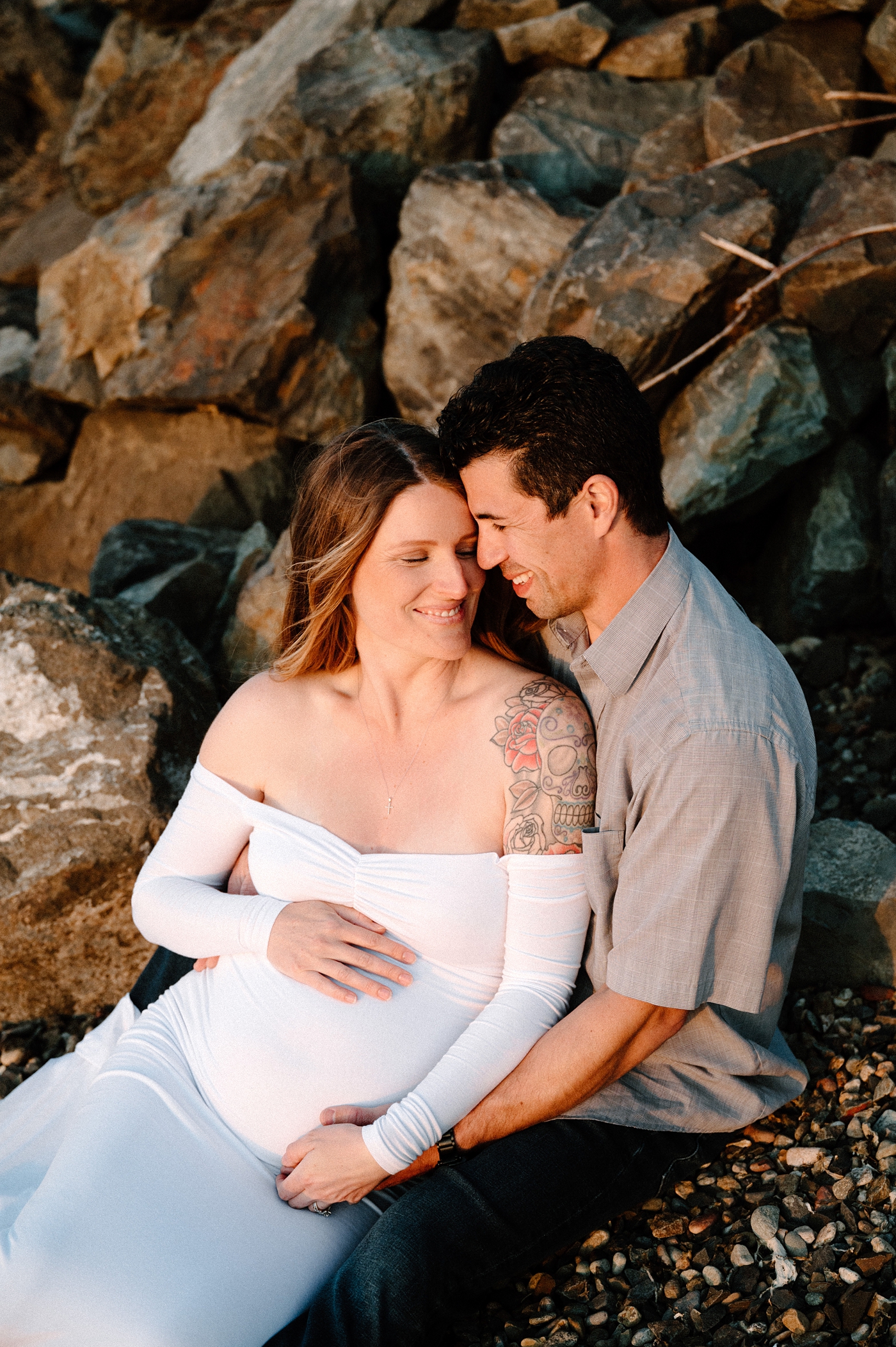 Parents to be beaming with pride as they lovingly embrace. Image by PNW maternity photographer Meg Newton.