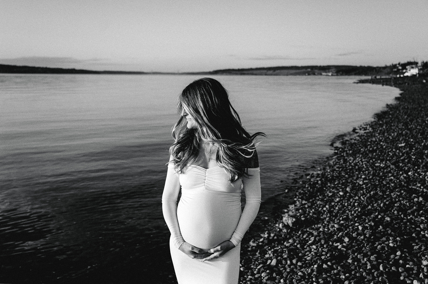 Mom-to-be stands near water's edge during maternity session. Image by PNW maternity photographer Meg Newton.