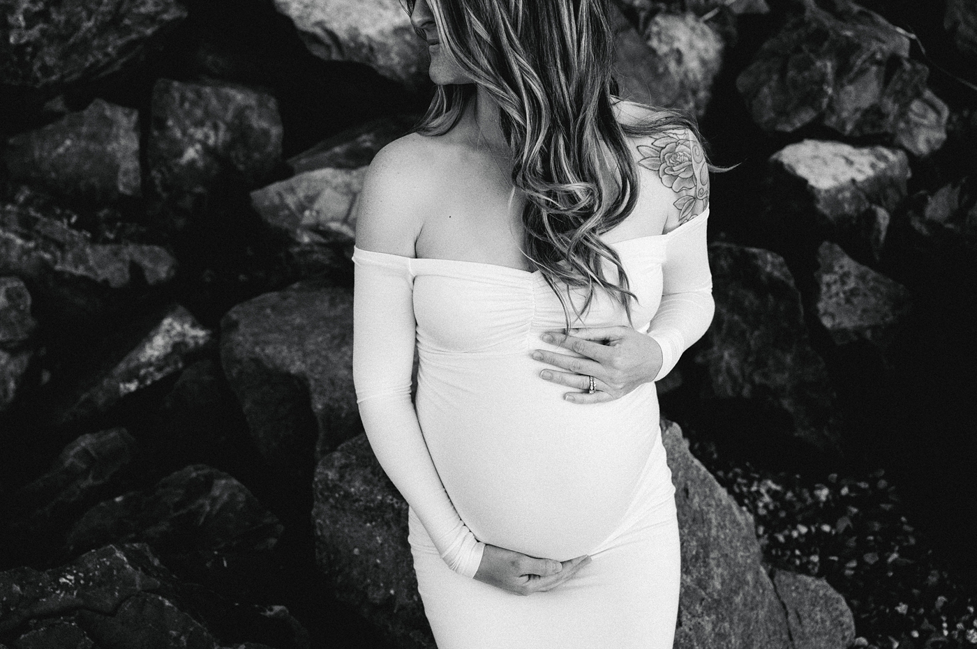 Mom to be embraces pregnant belly. Image by PNW maternity photographer Meg Newton.