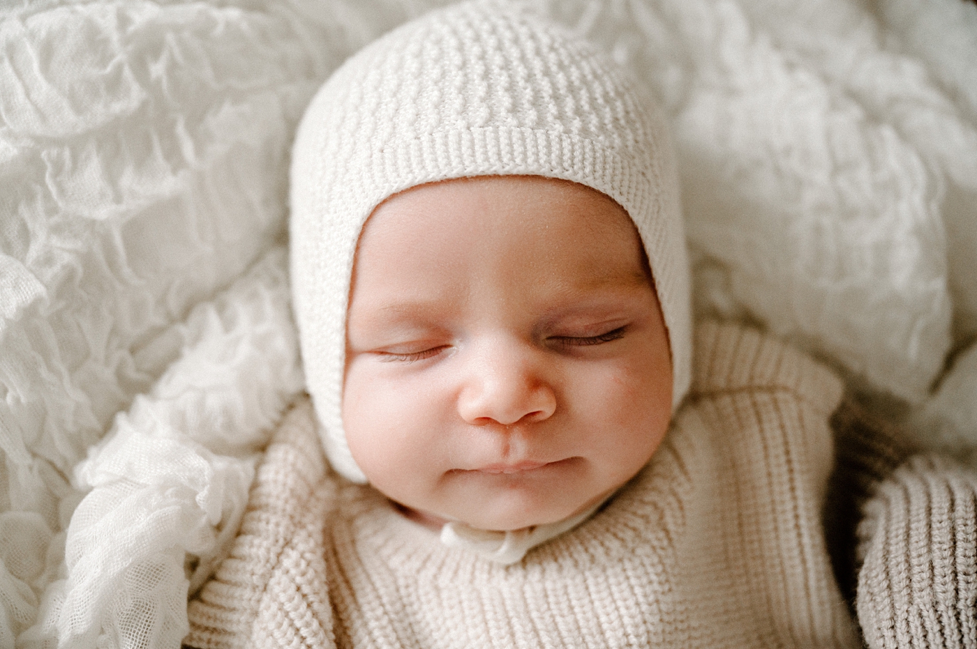 Sweet baby boy in knit bonnet. Photo by Meg Newton Photography.
