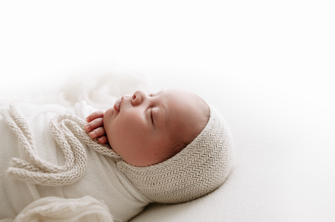 Profile of baby boy during his newborn session. Photo by Meg Newton Photography.