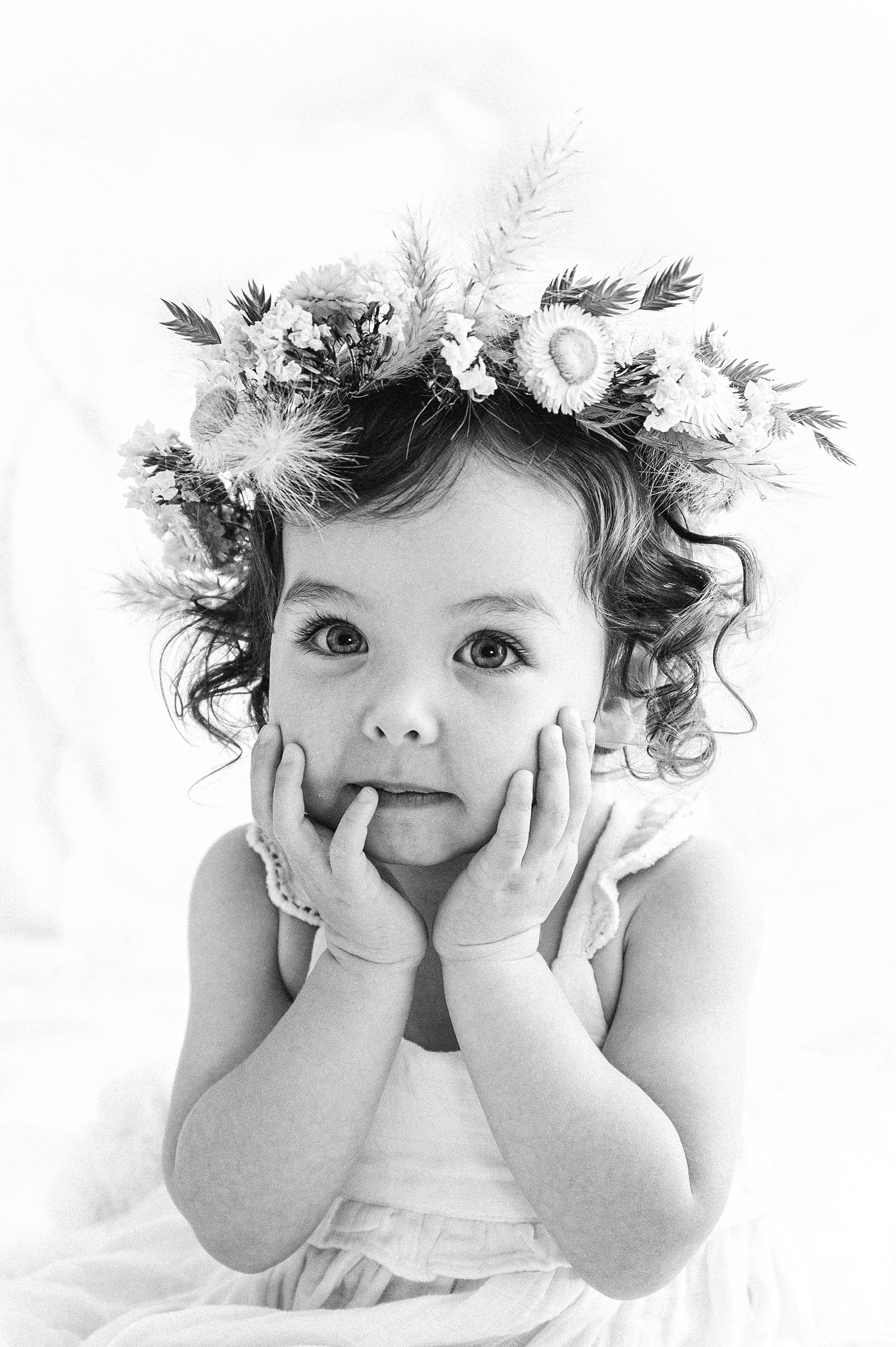 Gorgeous black and white image of little girl in floral crown. Photo by Meg Newton Photography.