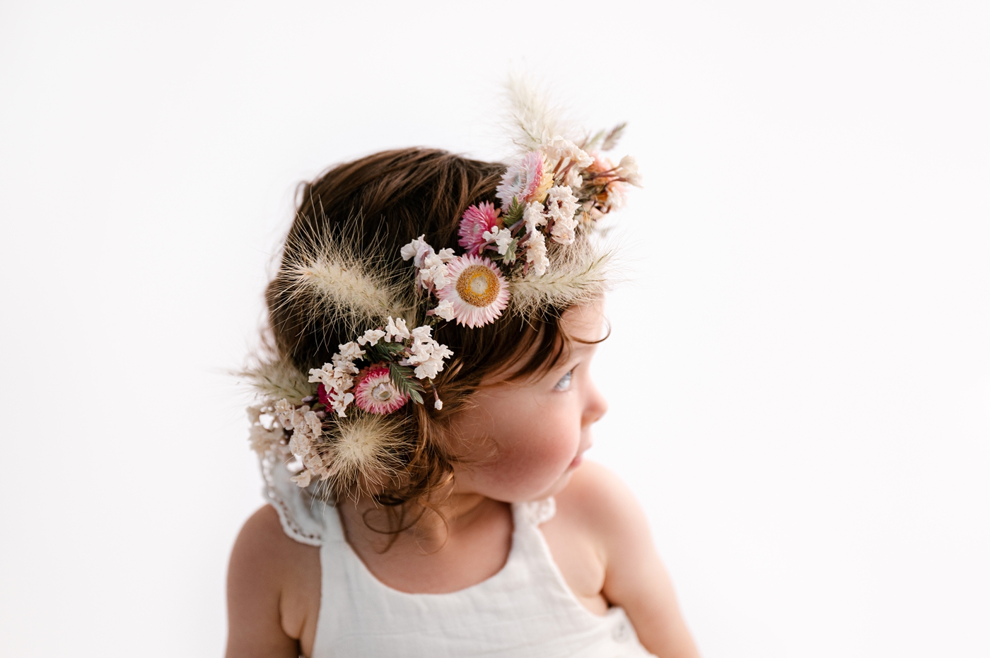 Dried floral crown in toddler girl's hair. Photo by Meg Newton Photography.