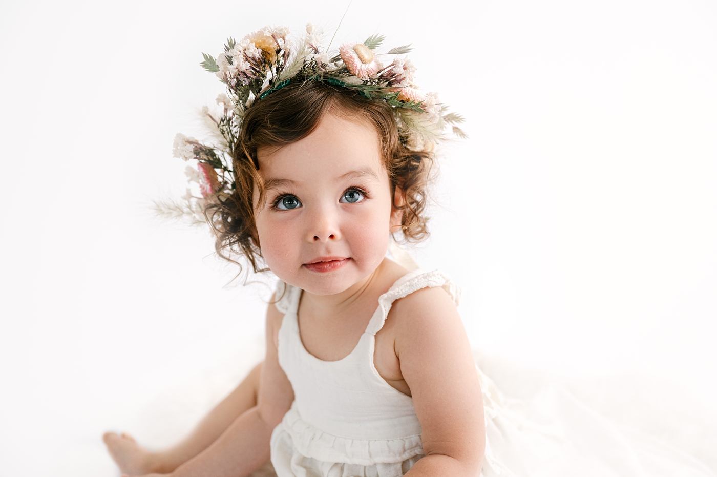 Baby girl in floral crown during Black Diamond, WA milestone session. Photo by Meg Newton Photography.