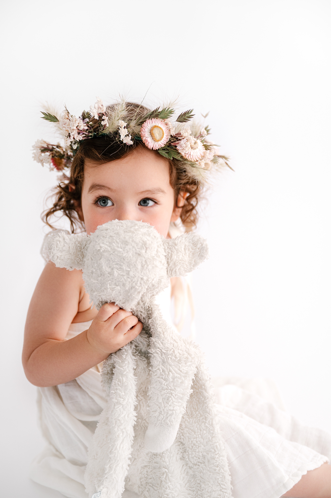 Little girl holds her special stuffed animal during Washington milestone session. Photo by Meg Newton Photography.